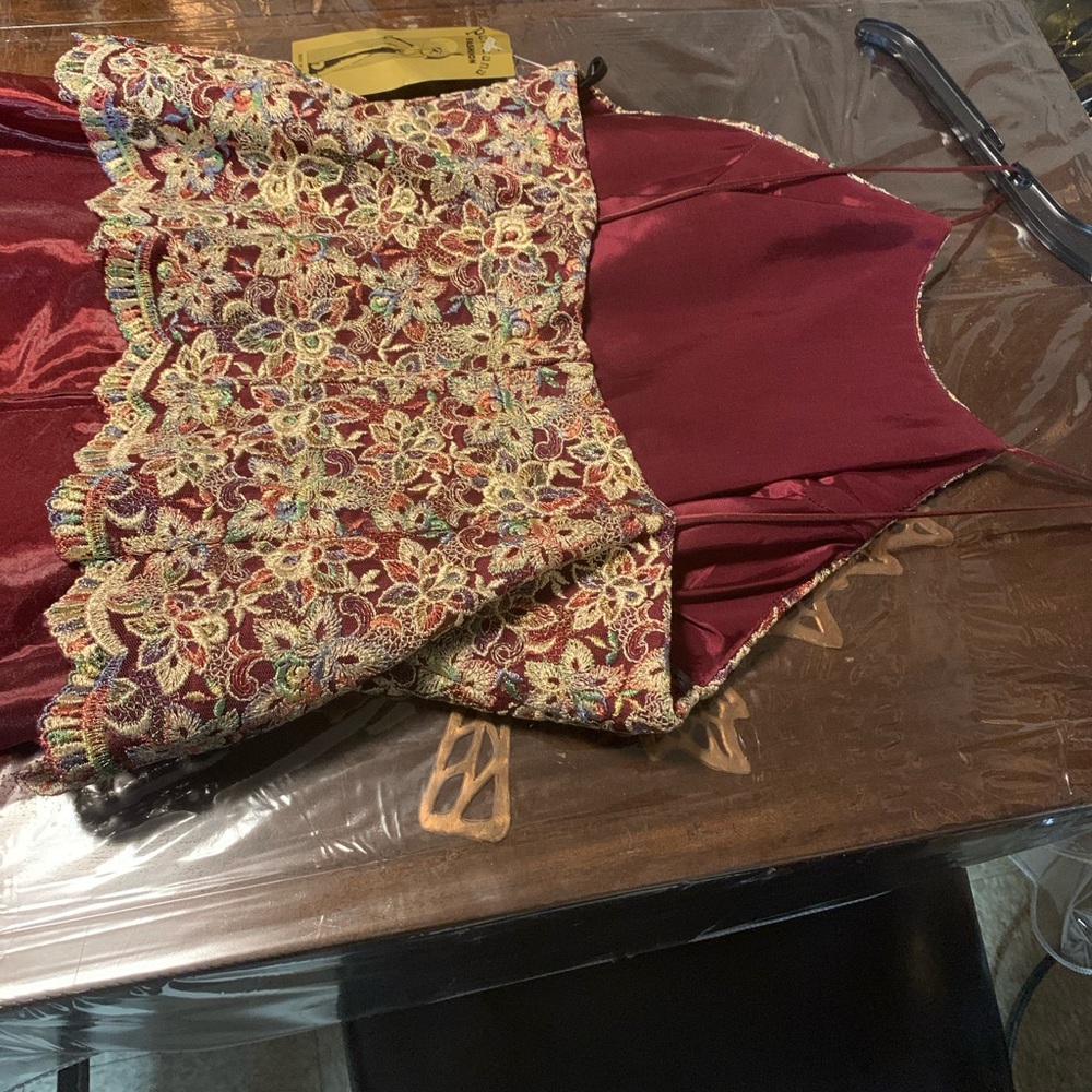 Beautiful burgundy with gold top dress .